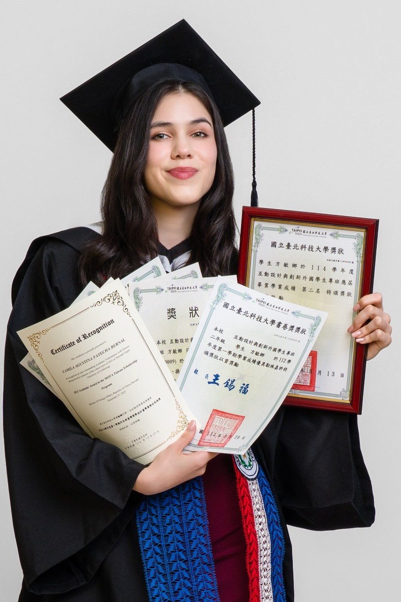 Camila at her NTUT graduation, holding her awards